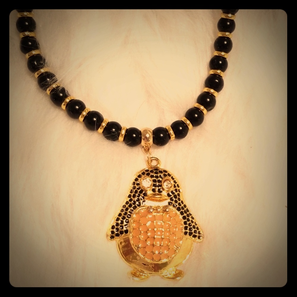 Gold and black beaded necklace with   Penguin  Rhinestones
